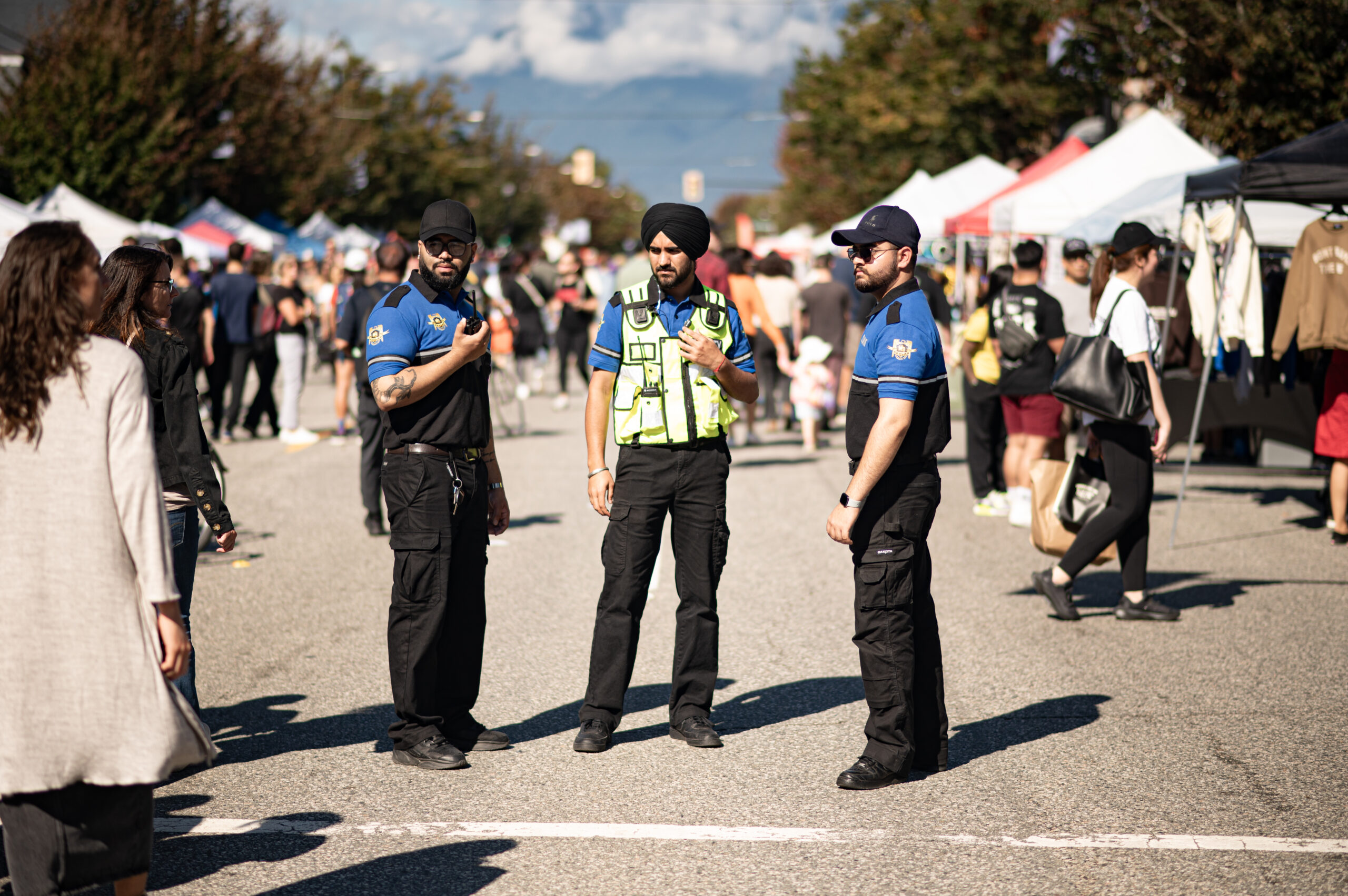 Security personnel at outdoor market event.